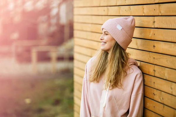 Fresco joven mujer en rosa sudadera con capucha sobre fondo de madera —  Fotos de Stock