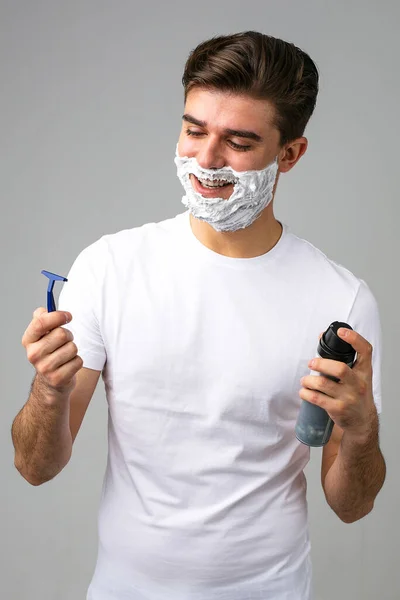 it\'s time to give up your beard, young man with foam on his face, ready tu shave