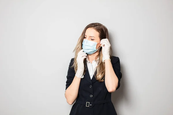 women fixing her protection mask against virus before going to work