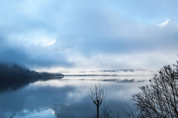 Mañana en el lago de montaña cubierto de niebla — Foto de Stock