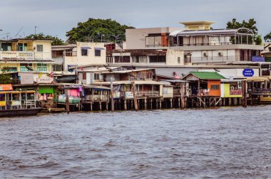 Poor district in Bangkok downtown with houses on the water