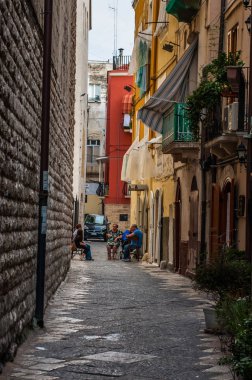 Bari, Italy - May 30 - local people sitting on the street and ta