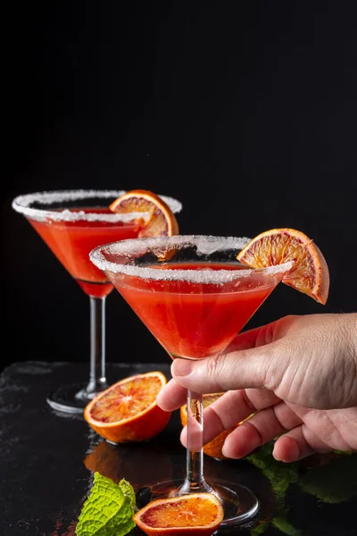 Närbild Kvinnans Hand Håller Ett Glas Blod Orange Cocktail Med — Stockfoto