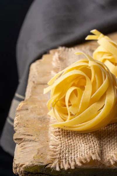 Top View Raw Tagliatelle Nests Burlap Rustic Table Dark Cloth — Stock Photo, Image