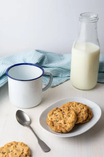 Top View Chocolate Chip Cookies Plate Milk Bottle Cup Spoon — Stock Photo, Image