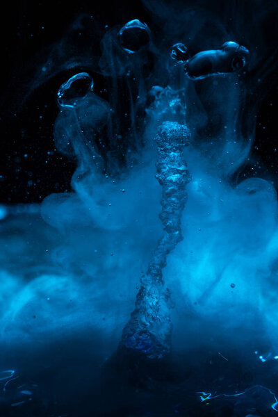 A geyser in blue fog and 4 drops similar to asteroids in a black starry sky