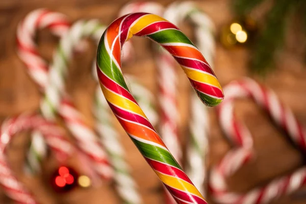 Christmas candy caramel on sticks in close-up on a background of caramel canes — Stock Photo, Image