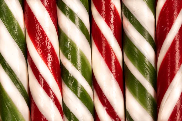 Background of New Year s caramel canes of green white and red colors — Stock Photo, Image