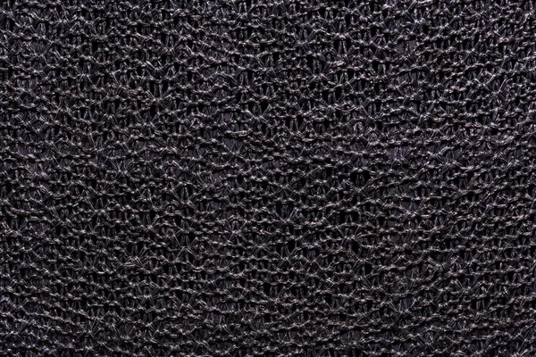 Dark gray fabric texture knitted on a frame — Stockfoto