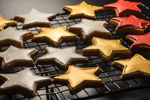 cookies in star shape on a grill on a black background close-up