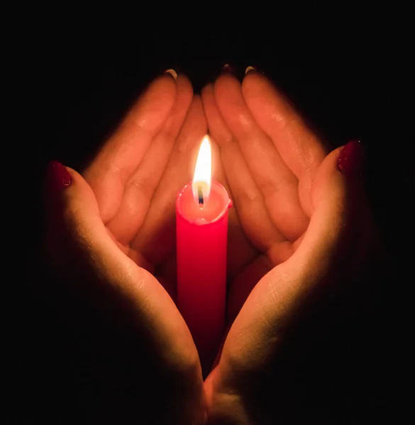 女人的手在黑暗中握住燃烧的蜡烛 拥抱着它 — 图库照片