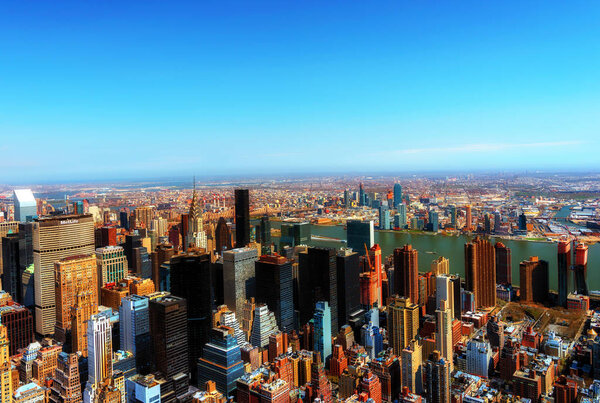 New York City, United States of America - April 12, : Manhattan downtown skyline with Empire State Building and skyscrapers seen from Top of the Rock observation deck on April 12, 2015.