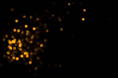 Siyah arkaplanda altın soyut bokeh.