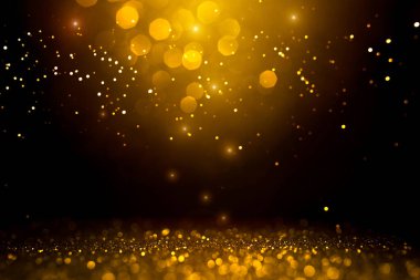 Siyah arkaplanda altın soyut bokeh.