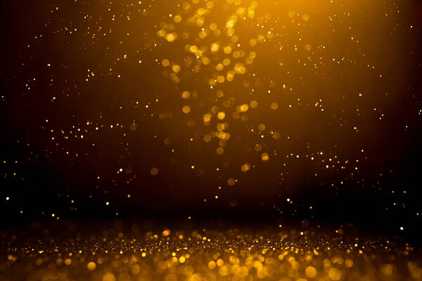 Golden abstract bokeh on black background. Holiday concept.