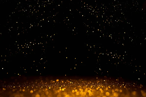 Bokeh abstracto dorado sobre fondo negro. — Foto de Stock
