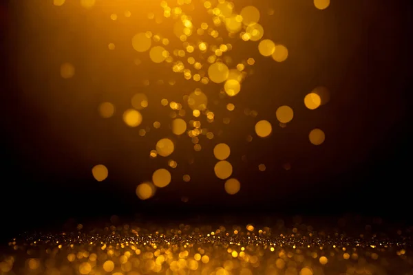 Bokeh abstrato dourado no fundo preto. — Fotografia de Stock