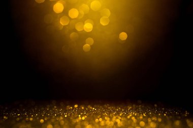 Siyah arkaplanda altın soyut bokeh.