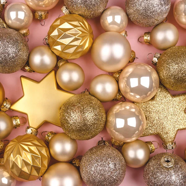 Festive pink background with gold and silver Christmas balls.