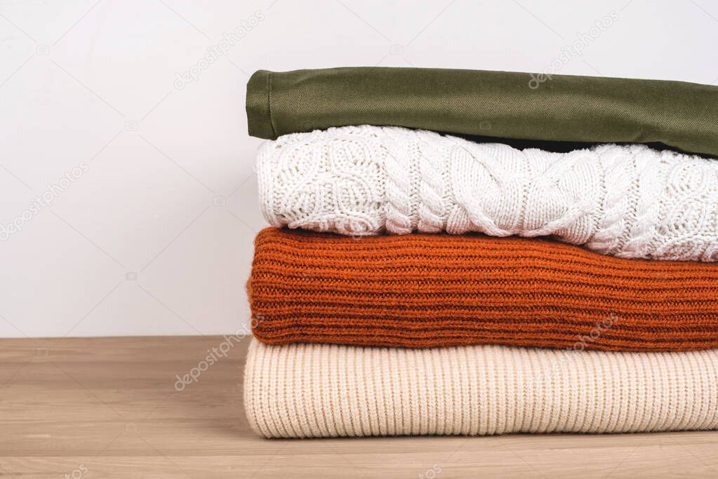 Pile of warm clothes on the table.