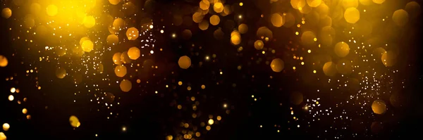 Bokeh abstrato dourado no fundo preto. — Fotografia de Stock