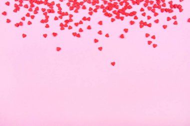 Pink background with red hearts. Valentine's day concept.