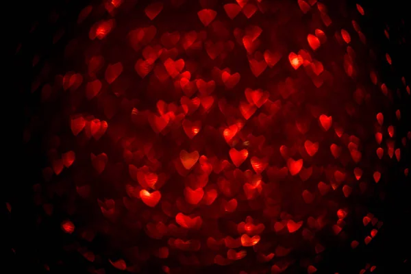 Fondo con bokeh rojo en forma de corazón . — Foto de Stock