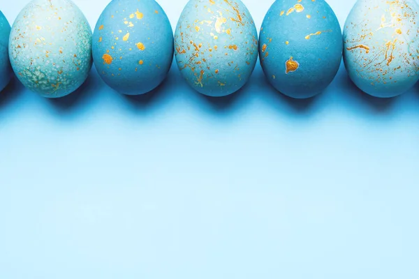 Easter frame of eggs painted in blue color.