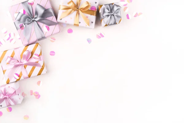 Several gift boxes with bows and confetti on a white background. — 스톡 사진