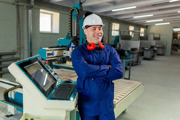 Worker in the Hard Hat Modern Factory CNC machine operator  . Successful, Handsome Man in Modern Industrial Environment.Emotions, Copy Space