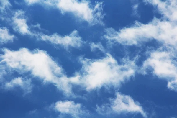 Blue sky with white and grey clouds