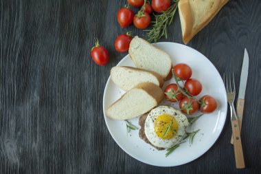 Beyaz tabakta servis edilen baharatlı sahanda yumurtalı biftek. Amerikan yemeği. Koyu ahşap arka plan. Yan görüş. Yakın plan. Metin için boşluk.