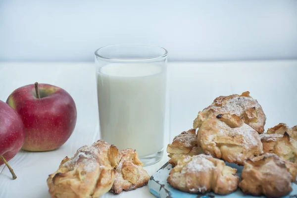 A glass of milk with homemade apple cookies. Cookies with apples. A glass of warm milk. Copy space. Dinner table. Healthy food balance.