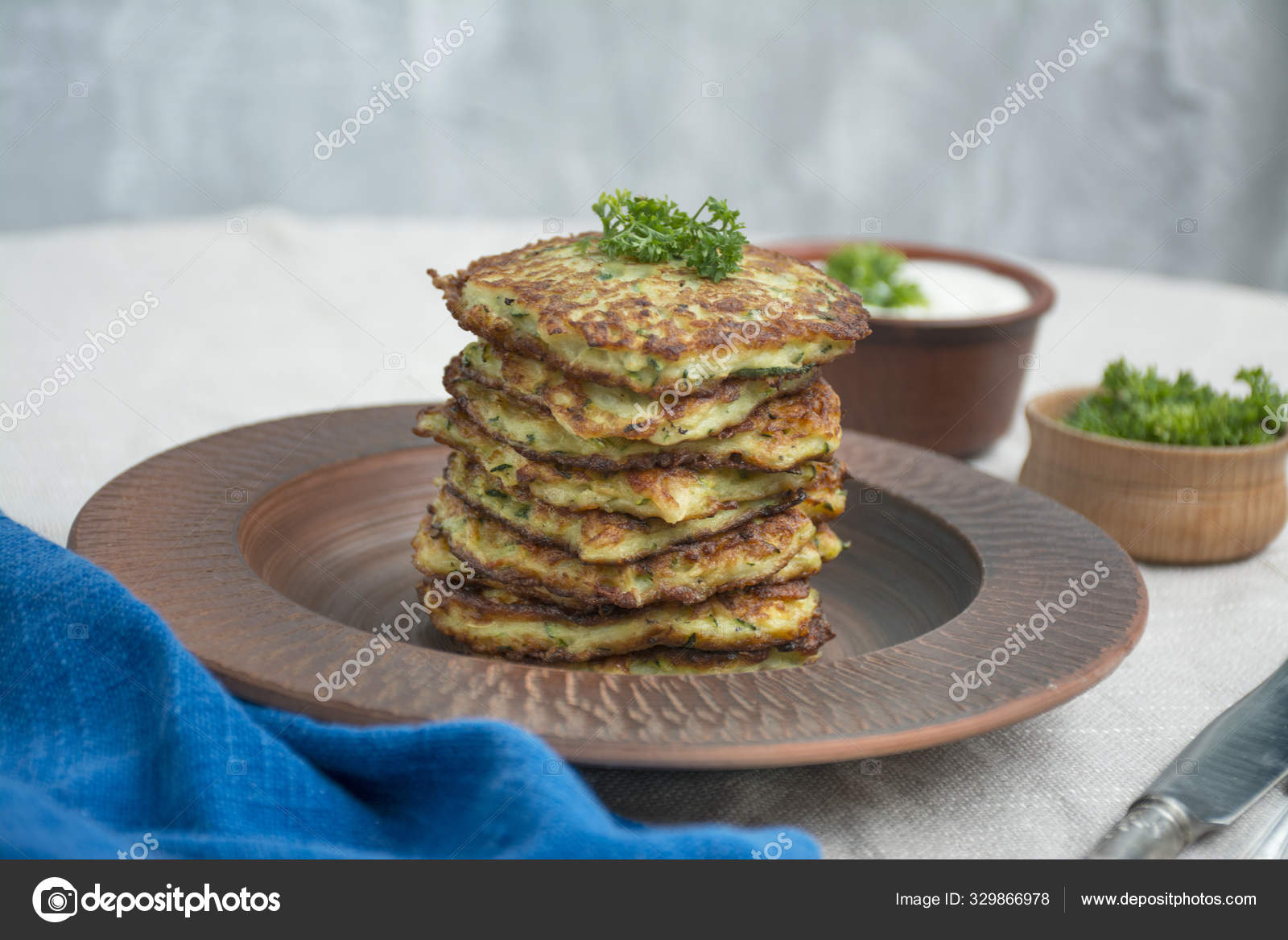 Zucchini fritters. Vegetarian zucchini pancakes with fresh herbs