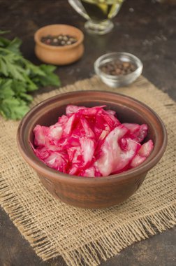 Coleslaw with beets in a clay bowl. Fermented foods. Homemade food. Sour food. Pickled vegetables. Vegetarian vegan food.