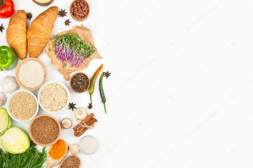 Healthy cereals, vegetables and spices on a light background. Healthy eating . Great food. Culinary background for recipes. Banner. Copy space.