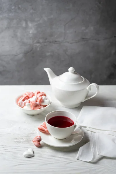 Romantic breakfast with red tea and meringue