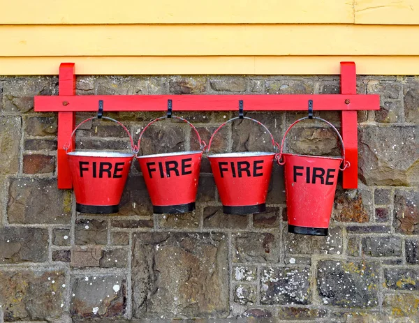 A row of 4 vintage fire buckets — Stock Photo, Image