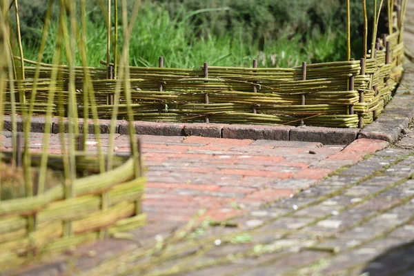 traditional handmade garden edging made with woven willow