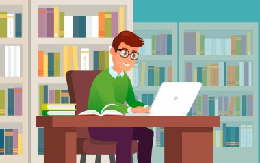 Kütüphanede dizüstü bilgisayarda çalışan ya da okuyan genç adam