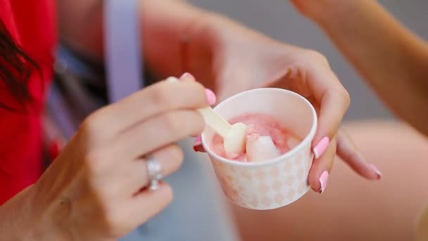 Close up ice cream in hands. Young female model eating ice cream cone on summer day — Stock Video