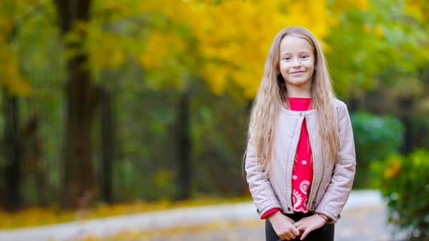Adorable little girl outdoors at beautiful autumn day — Stock Video