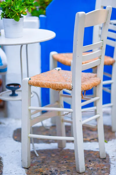 Two chairs on a street of typical greek traditional village on Mykonos Island, Greece, Europe — Stock Photo, Image