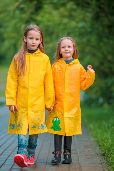 Adorable little girls under the rain on warm autumn day — Stock Photo, Image