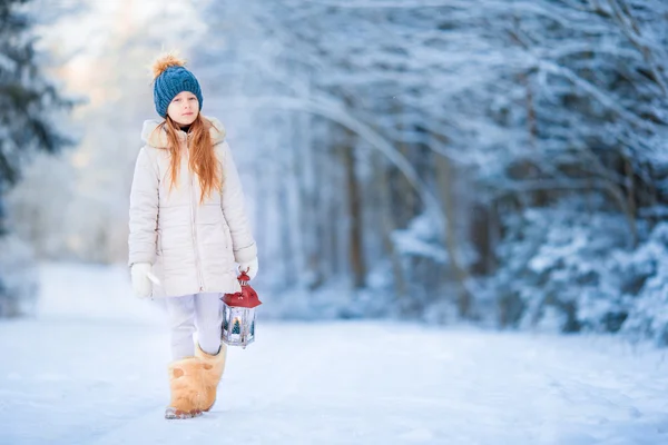 Little girl with latern in frozen forest on Christmas eve — Stock Photo, Image