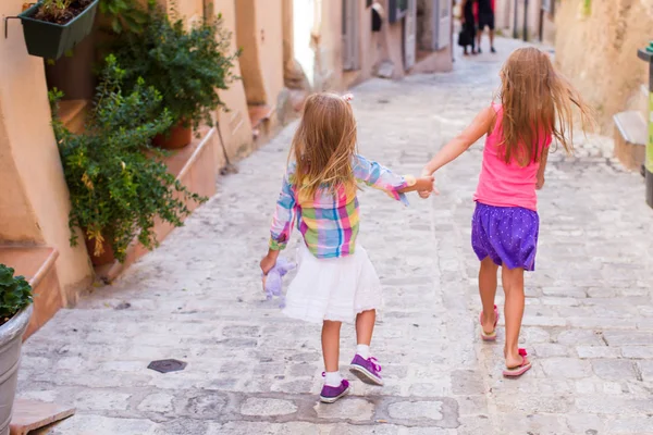 Adorable happy little girls outdoors in narrow street at small city — Stock Photo, Image