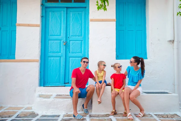 Family in Mykonos on summer vacation. Parents and kids at narrow street in traditional greek village — Stock Photo, Image