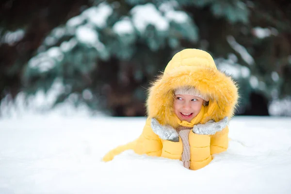 Portrait of little happy adorable girl in snow sunny winter day — Stock Photo, Image