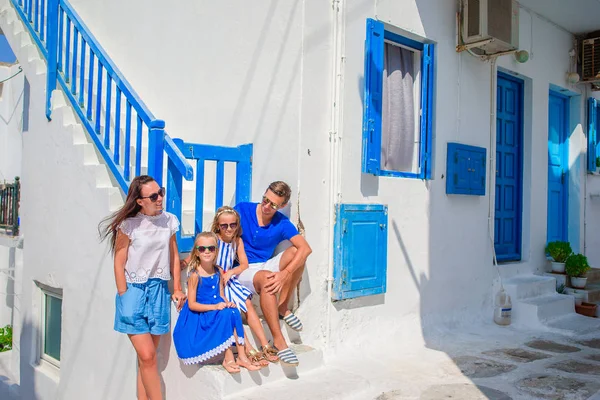 Family vacation in Europe. Parents and kids at street of typical greek traditional village on Mykonos Island, in Greece — Stock Photo, Image