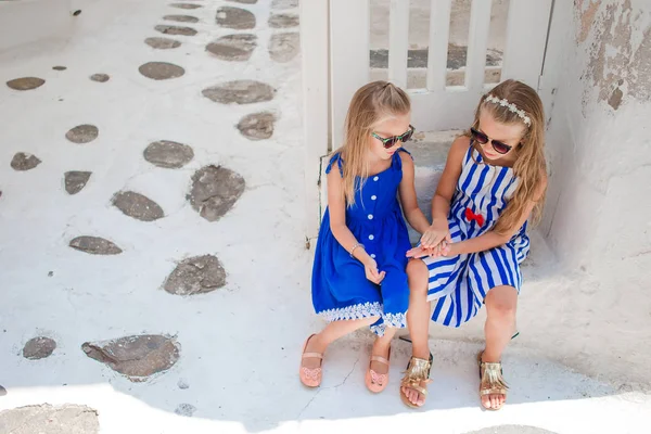 Little girls at street of typical greek traditional village in Greece — Stock Photo, Image